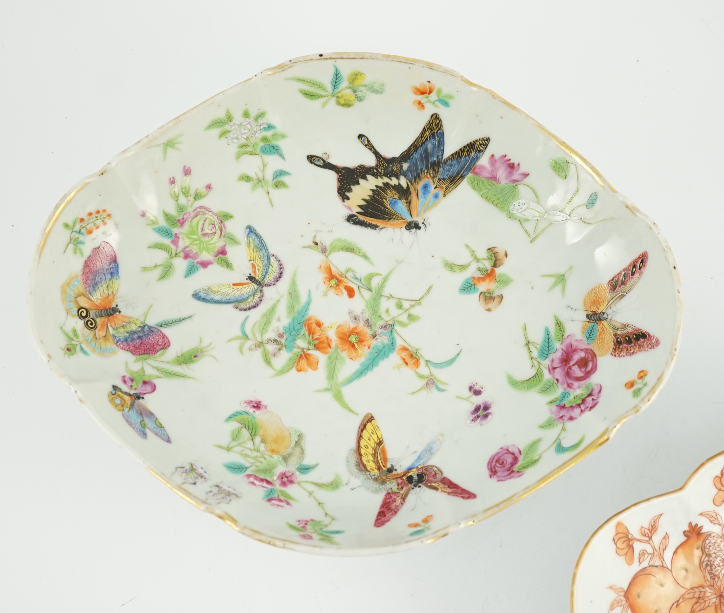 A Chinese famille rose 'butterfly and flowers' dish, Daoguang period and an iron red enamelled 'sanduo' dish, late 19th century